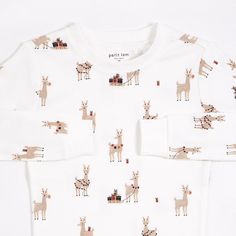 These playful PJs feature Rudy & The Reindeers, so are the perfect set to keep for Christmas eve. With a long-sleeved top and long pants, the set is cozy and warm for chilly nights watching out for Santa. Made from organic cotton rib, the PJs are breathable and flexible – giving them plenty of room to open presents, play and cause mischief. With elasticated cuffs and ankles, the two-piece set is easy to wear for a whole day or night of festive fun. Details: Composition: 100% Organic cotton rib R Holiday Pjs, White Pajamas, Best Pajamas, Childrens Christmas, Pyjama Set, Pj Sets, Organic Baby, Christmas Prints, Christmas Baby