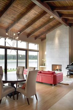 a living room filled with furniture and a piano in the middle of it's walls