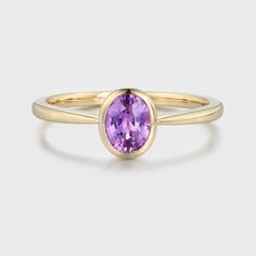 Oval Cut Amethyst Bezel Ring—a stunning and elegant choice that beautifully showcases the deep and regal purple hue of an oval-cut amethyst gemstone set in the luxurious embrace of 14k yellow gold. This ring is a celebration of your unique style and a promise of timeless elegance. Luxury Purple Amethyst Oval Cabochon Ring, Elegant Purple Sapphire Ring For Formal Occasions, Oval Yellow Gold Amethyst Ring With Polished Finish, Oval Amethyst Ring In Yellow Gold With Polished Finish, Purple Sapphire Oval Ring For Wedding, Purple Oval Sapphire Wedding Ring, Elegant Oval Purple Rings, Elegant Amethyst Oval Cabochon Ring, Elegant Purple Solitaire Birthstone Ring