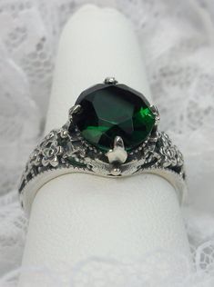 "Simulated Green Emerald Ring Cameo Design#62 Custom Made Inspired by the Art Nouveau/Arts & Crafts movement of the early 1900s, I now offer this lovely reproduction in sterling silver. This gorgeous ring is set with a flawless 4ct Simulated green emerald. This simulated emerald has perfect color and clarity. The full cut 4ct oval gem is 11mm (7/16th inch) L by 9mm W (3/8th\"). The ring sits 6mm off the finger. The inside of the band is marked 925 for sterling Notice the beautiful leaf desig Jostens Class Rings, Green Emerald Ring, Gothic Rings, Green Jewelry, Mystic Topaz, Green Peridot, Silver Art, Filigree Ring, Engraved Items