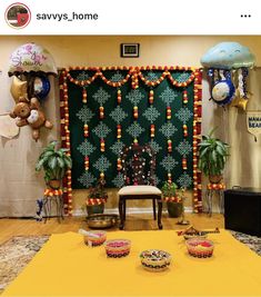 a room decorated with balloons and decorations for a party or celebration, including plates on the floor