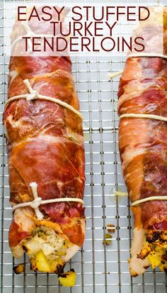 two wrapped stuffed turkeys sitting on top of a cooling rack