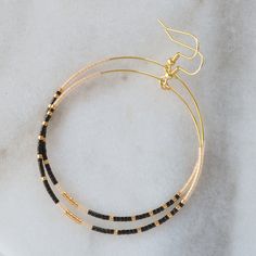 You asked for bigger beaded hoops and Libby & Smee answered! These dangly hoop earrings are the pieces you'll grab every day when you want a little something fun without a lot of fuss. Bonus: They look great dressed up or super casual. beaded hoops with tiny glass seed beads style: NOIR — black, gold and frosted blush choose from two large sizes: BIG, a teardrop shape approximately 1.75 inches wide and 2.75 inches long, or BIGGER, a circle shape 2.25 inches wide and 3 inches long gold-plated Adjustable Hoop Earrings With Black Beads, Adjustable Black Beaded Hoop Earrings, Adjustable Hoop Beaded Earrings With Black Beads, Everyday Minimalist Beaded Hoop Earrings, Hoop Earrings Diy, Diy Seed Bead Earrings, Wire Hoop Earrings, Beads Style, Bead Weaving Tutorials