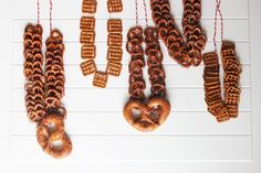 some pretzels hanging from strings on a wall