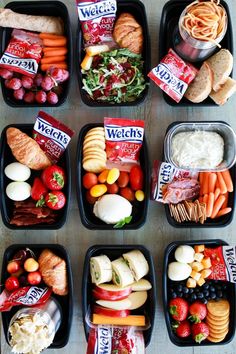 several trays filled with different types of food