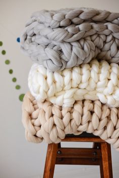 four different colors of yarn stacked on top of each other