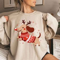 Christmas Dachshund Sweatshirt for Dog Lovers, Dachshund Crewneck, Dachshund Mom Sweater, Dog Owner Christmas Gift, Funny Christmas Shirt, Cute Dachshund Xmas Gifts, Holiday Sweater PRODUCT DESCRIPTION: Ideal for any situation, a unisex heavy blend crewneck sweatshirt is pure comfort. These garments are made from polyester and cotton. This combination helps designs come out looking fresh and beautiful. The collar is ribbed knit, so it retains its shape even after washing. There are no itchy side Winter Dog Print Crew Neck Top, Winter Crew Neck Top With Dog Print, Dog Christmas Gift, Funny Christmas Sweater, Christmas Dachshund, Dachshund Shirt, Dachshund Mom, Mom Sweater, Funny Christmas Sweaters