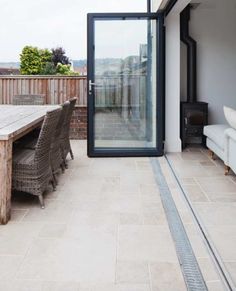 an outdoor dining area with patio furniture and sliding glass doors on the side of a house