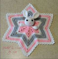 a crocheted star with a stuffed animal on it