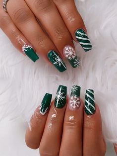 Perfect for the holiday season, this nail design captures the essence of a snowy winter day. The rich, forest-green base is adorned with hand-painted white snowflakes, instantly evoking a festive, wintry atmosphere. Candy cane stripes are cleverly incorporated, adding a playful yet chic element to the design. Emerald Green Xmas Nails, Green Nails With Snowflake, Green Candy Cane Nails, Green And Red Nail Designs, Green Christmas Nails Square, Christmas Nail Ideas Green, White And Green Christmas Nails, Winter Green Nail Designs, Green And Silver Christmas Nails