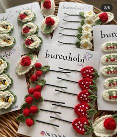 crocheted hair pins with flowers and ladybugs on them in a basket