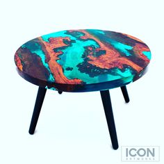 a colorful table with black legs and an orange, blue and green design on it