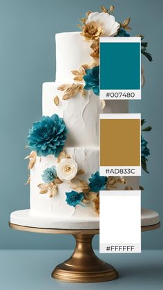 a three tiered cake with blue and gold flowers on the side, along with matching colors