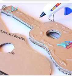 cardboard guitar cut out with scissors and glue