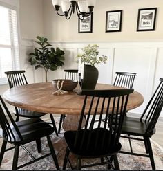 a dining room table with four chairs around it