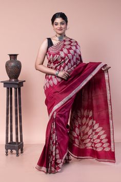 Ideal festive wear, this cherry maroon color saree has been specially designed with a discharge paint style. A sober saree for those who don't like loud fashion. COLOUR: Cherry Maroon and White CRAFT: Hand block printing  DIMENSIONS: Saree length 6.5 Mts., Saree width 1.14 Mts. Blouse piece inclusive. NET QUANTITY: 1 pc saree PATTERN: Leaf PRODUCT MATERIAL: Handwoven Pure Mulberry Silk saree PRODUCT TYPE: Saree with Blouse piece WEIGHT: 350 g WASH INSTRUCTIONS: Dry cleaning is recommended for this product. Iron inside out. Do not bleach and expose this product to excessive heat and sunlight for long. Luxury Cotton Saree For Festive Occasions, Luxury Cotton Saree For Festive Season, Cheap Red Art Silk Saree, Cheap Cotton Saree With Self Design, Luxury Festive Cotton Saree, Cheap Cotton Self-design Saree, Cheap Embroidered Cotton Saree, Cheap Festive Cotton Saree, Luxury Cotton Silk Saree, Elegant Style