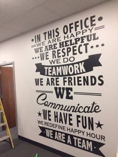 an office wall with some words on it