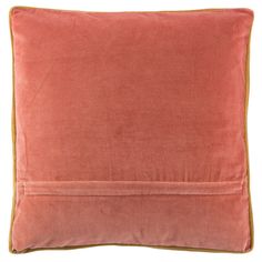 an orange velvet pillow with gold piping on the bottom and side, against a white background