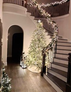 a staircase decorated with christmas trees and lights