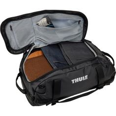 an open duffel bag with clothing inside it