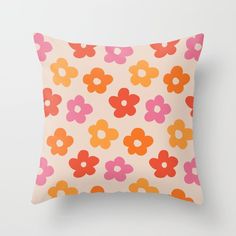 an orange and pink pillow with flowers on it