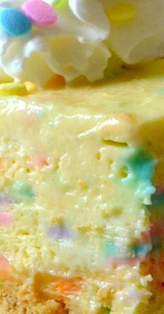 a piece of cake with white frosting and sprinkles