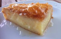 a close up of a piece of cake on a white plate with orange toppings