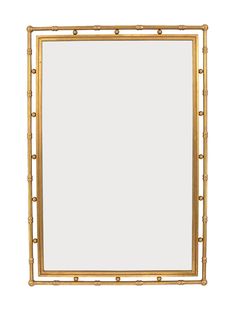 a gold framed mirror sitting on top of a white wall