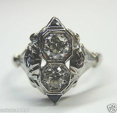 an antique diamond ring is shown on a white surface