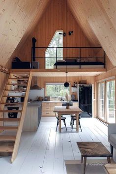 an open floor plan with stairs leading up to the loft