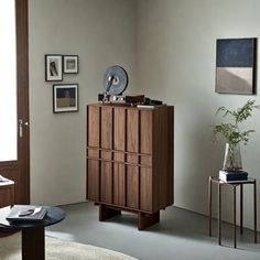 a living room filled with furniture and pictures on the wall