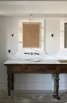 a bathroom with two sinks and mirrors on the wall