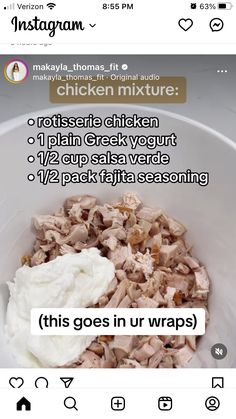 a bowl filled with chicken and yogurt sitting on top of a table