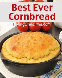 the best ever cornbread in a cast iron skillet on a table with plates and utensils