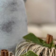 two small pumpkins sitting on top of a table next to some twine and cinnamon sticks