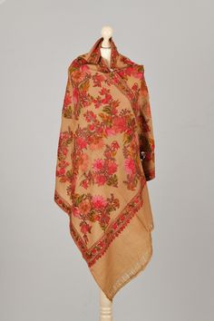 Khaki super soft wool Scarf, embroidered with Red, Orange, Green, Pink, and Rose in traditional Kashmiri Floral design with silk viscose yarn.   Highlights *Handmade in Kashmir  *Materials: Super Soft Wool, Embroided with Silk and viscose  *Length: 200 cm  *Width: 70 cm  Description Elegant and authentic Kashmiri scarf in Super Soft wool, embroidered with Red, Orange, Green, Pink, and Rose Silk viscose yarn.  Extremely comfortable to wear. Perfect for everyday or formal use.  This scarf is produ Traditional Brown Embroidered Shawl, Traditional Embroidered Brown Shawl, Winter Festive Embroidered Pashmina Shawl, Embroidered Festive Winter Pashmina Shawl, Traditional Cream Pashmina Shawl, Traditional Shawl With Resham Embroidery For Winter, Traditional Winter Dupatta With Traditional Patterns, Traditional Embroidered Winter Shawl, Winter Embroidered Shawl With Traditional Drape