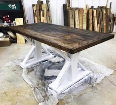 a wooden table sitting on top of a pile of wood