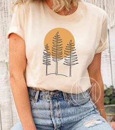 The perfect shirt for someone who loves the outdoors. Pine Tree T Shirt Forest Themed Shirt Camping Gift Shirt Adventure is Calling Sunset TShirt Wildlife Tee Wilderness Shirt Wisconsin Tee Bella Canvas 3001T:  T-Shirt Sizing Please reference the size chart before selecting shirt size.  Use one of your own t-shirts to measure the size and fit.  Then compare with the size chart provided to ensure an accurate fit. T-Shirt Materials 100% combed and ring-spun cotton. Heather colors are 90% combed an Trendy Tshirt Designs 2023, T Shirt Cricut Ideas, Nature T Shirt, Outdoor Tshirt Design, Simple Graphic Tees, Outdoorsy Shirt, Adventure Shirts, Tree T Shirt, Adventure Is Calling