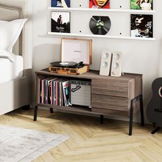 a record player sitting on top of a wooden cabinet