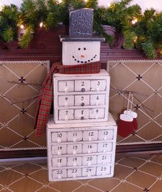 a snowman made out of drawers in front of a christmas tree