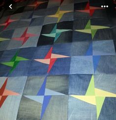 a quilt made to look like stars on a bed