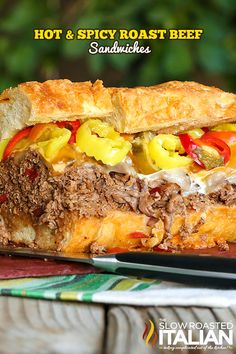 a sandwich with meat, peppers and cheese