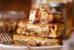 a stack of waffles sitting on top of a white plate next to a fork