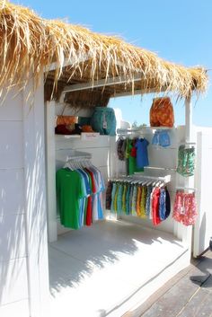 a small hut with clothes on display in it