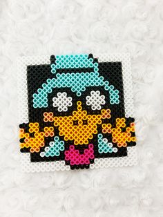 a piece of art made out of perler beads with an image of a cartoon character on it