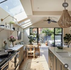 a kitchen with an open floor plan and skylights