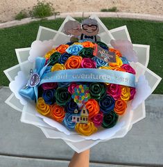 a person holding a bouquet of colorful paper flowers