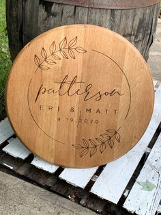 a wooden sign that says pattieson and mat on it next to a barrel