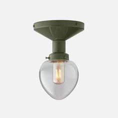 a green light fixture with a clear glass shade