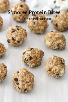 cookies and marshmallows are arranged on a sheet of parchment paper, ready to be baked